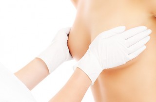 A midsection of a doctor examining breast
